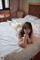 A woman laying on a bed in a hotel room.